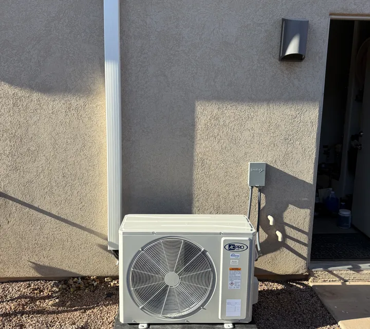 Freshly replaced high-efficiency condenser installed beside a Southern Utah home