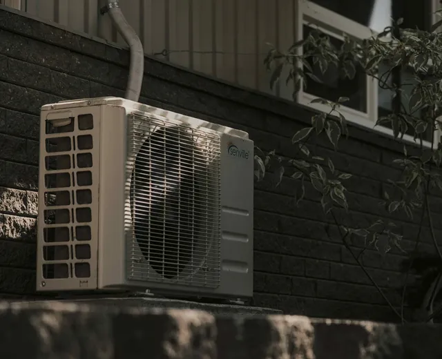 Ductless mini-split condenser installed on an exterior wall